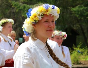 A young woman wears a flower wreath. From Kursa 2016, at the West Coast Latvian Education Center.